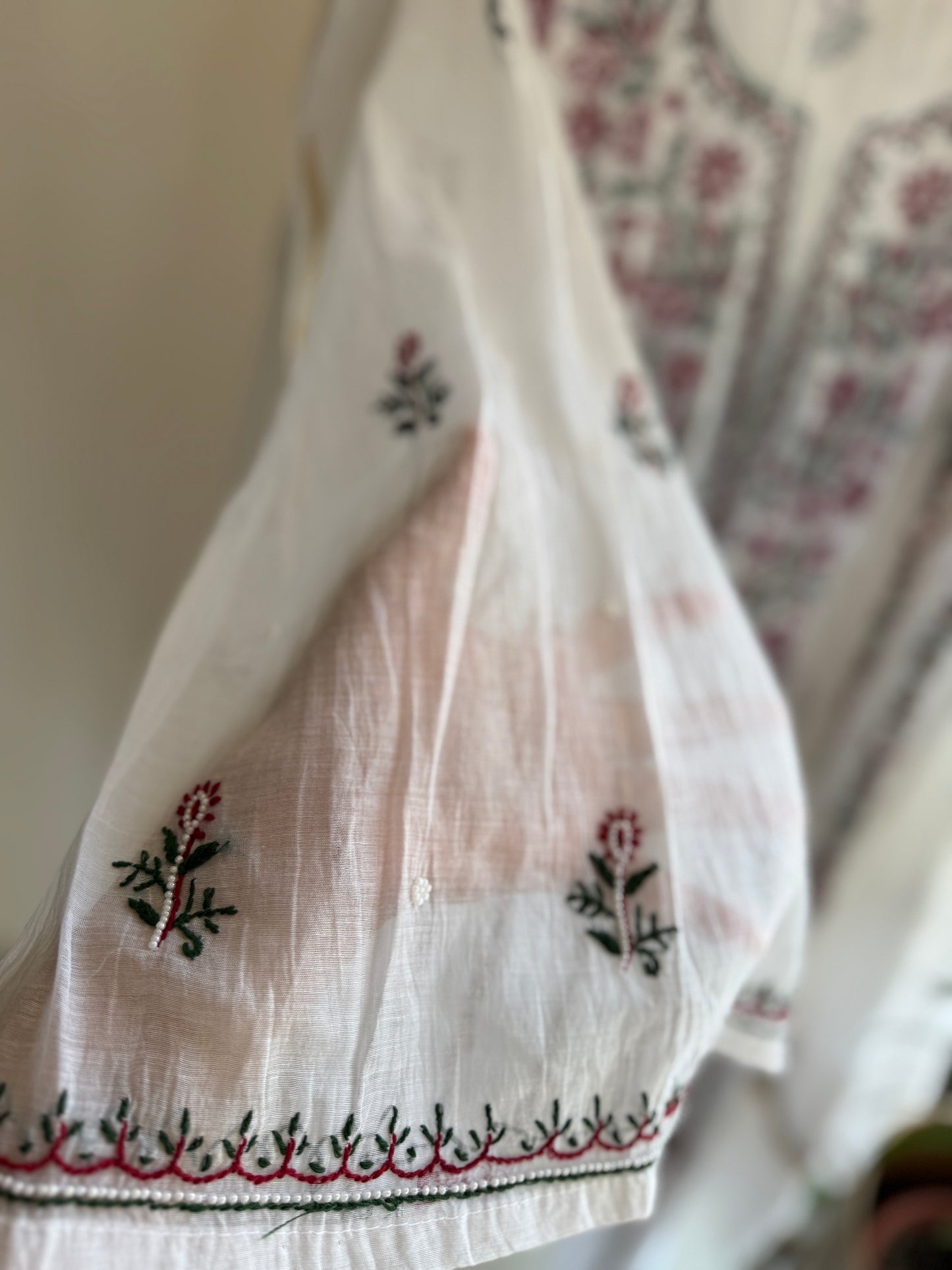 Close-up of hand embroidered Chikankari with pearl and cutdana embellishments on Mul Chanderi Anarkali
