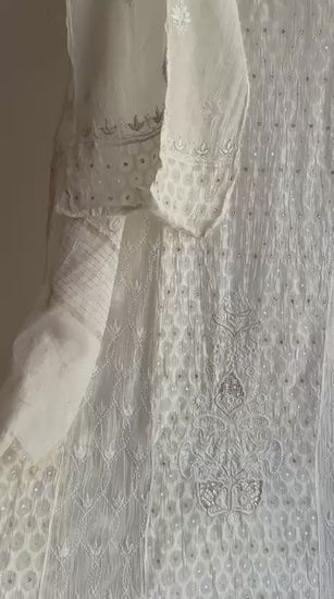 Close-up of Lucknowi Chikankari hand embroidery on Mul Chanderi fabric with floral motifs and fine border detailing
