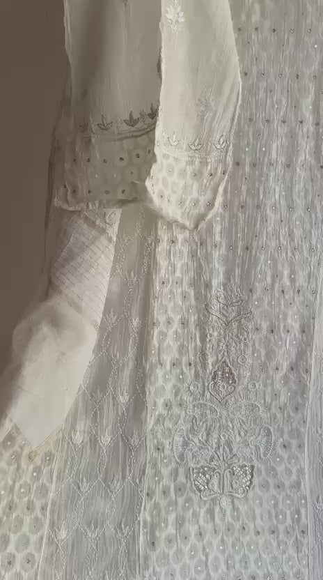 Close-up of Lucknowi Chikankari hand embroidery on Mul Chanderi fabric with floral motifs and fine border detailing